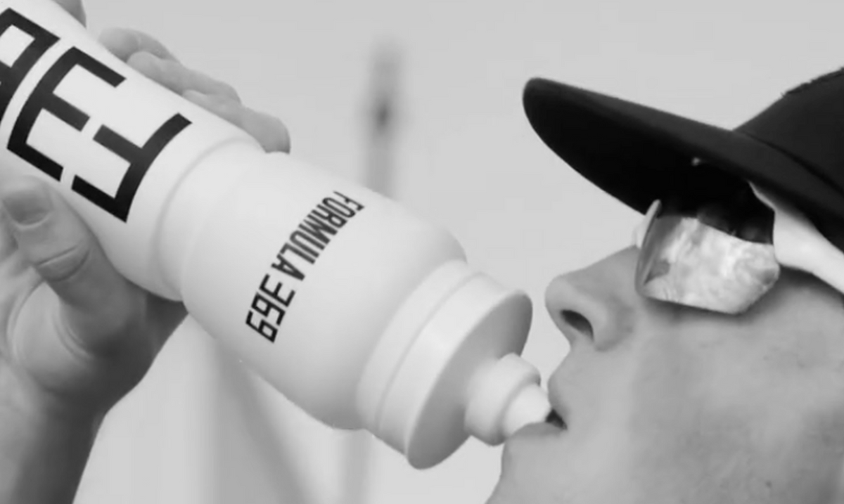 Athlete drinking Formula 369 from a training bottle