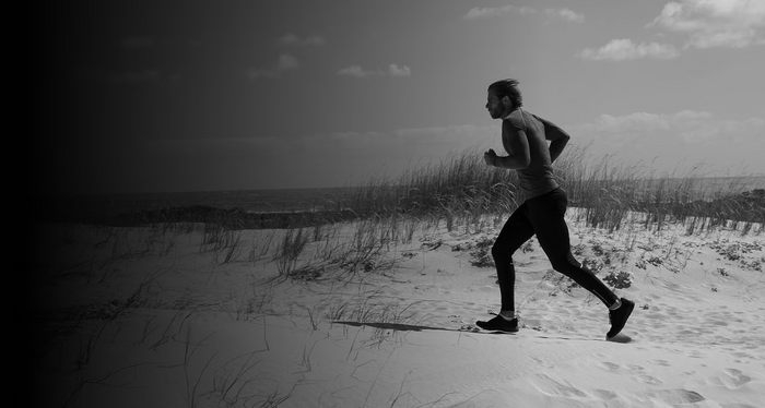 Runner on a sandy trail near the coast